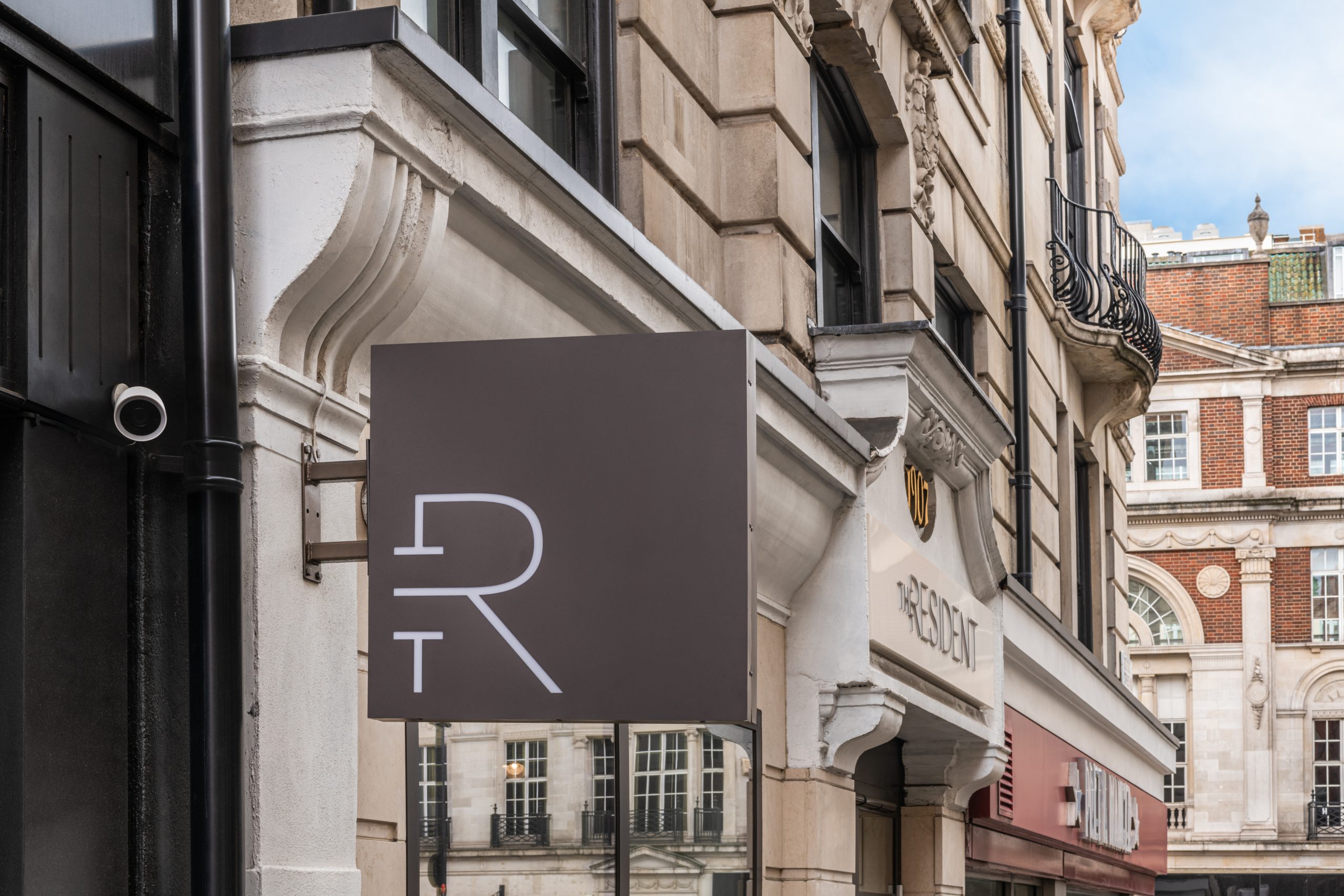 A hanging sign of The Resident Covent Garden.