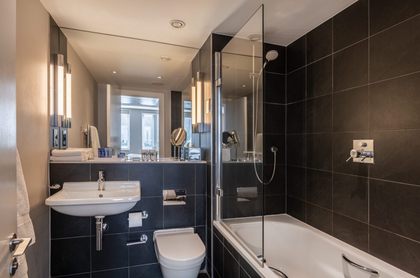A small bathroom with a built-in bathtub and shower.