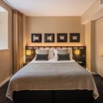 A suite with a double bed, bedside tables and built in wardrobes, located in Victoria.