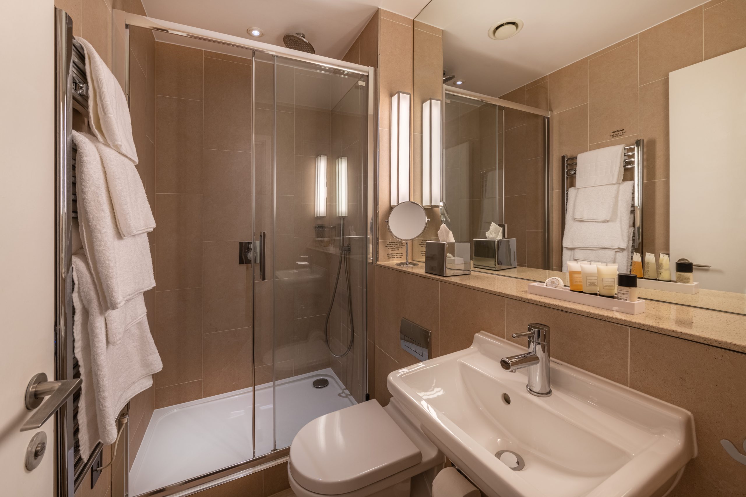 Bathroom with a walk-in shower and amenities.