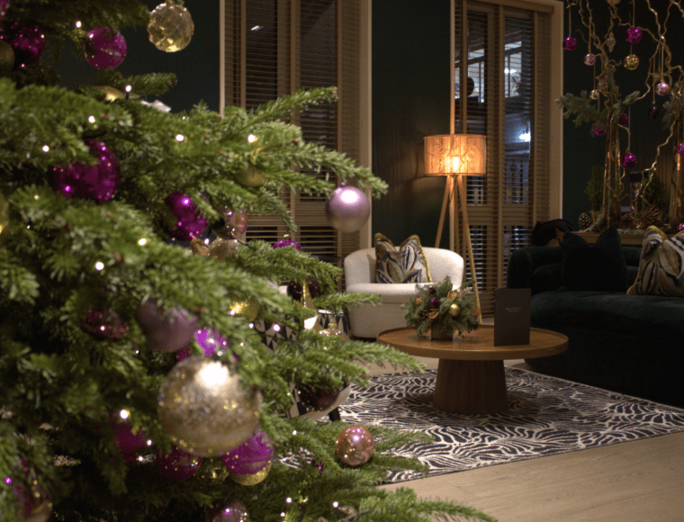 The Resident Soho at Christmas. The lounge area includes a decorated Christmas tree, a sofa and coffee table.